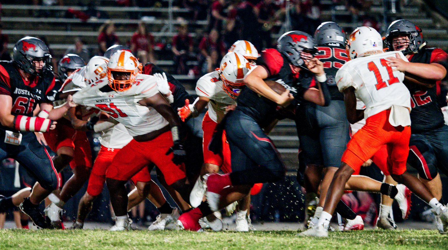 The Yellowjacket defense fights its way through the Hughes Springs line to get to the ball carrier Friday.